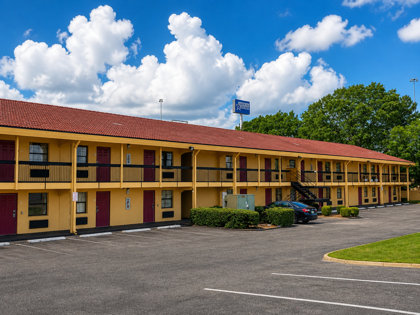 Wide exterior view of Studio Lodge Montgomery and parking area