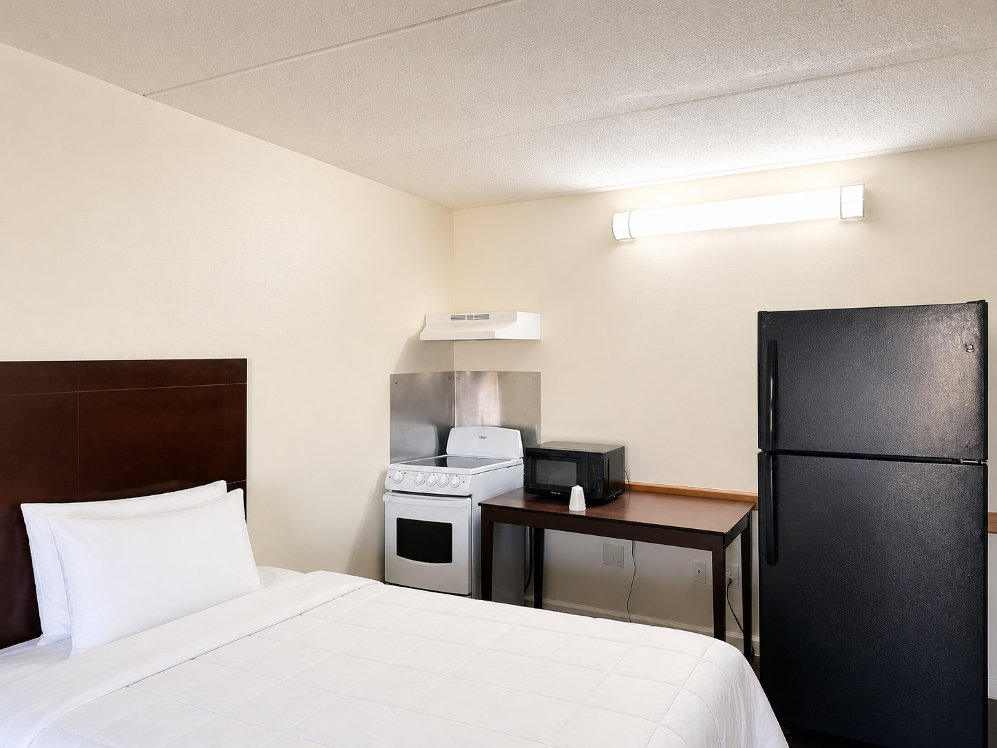 Montgomery queen room with kitchenette and full-size refrigerator