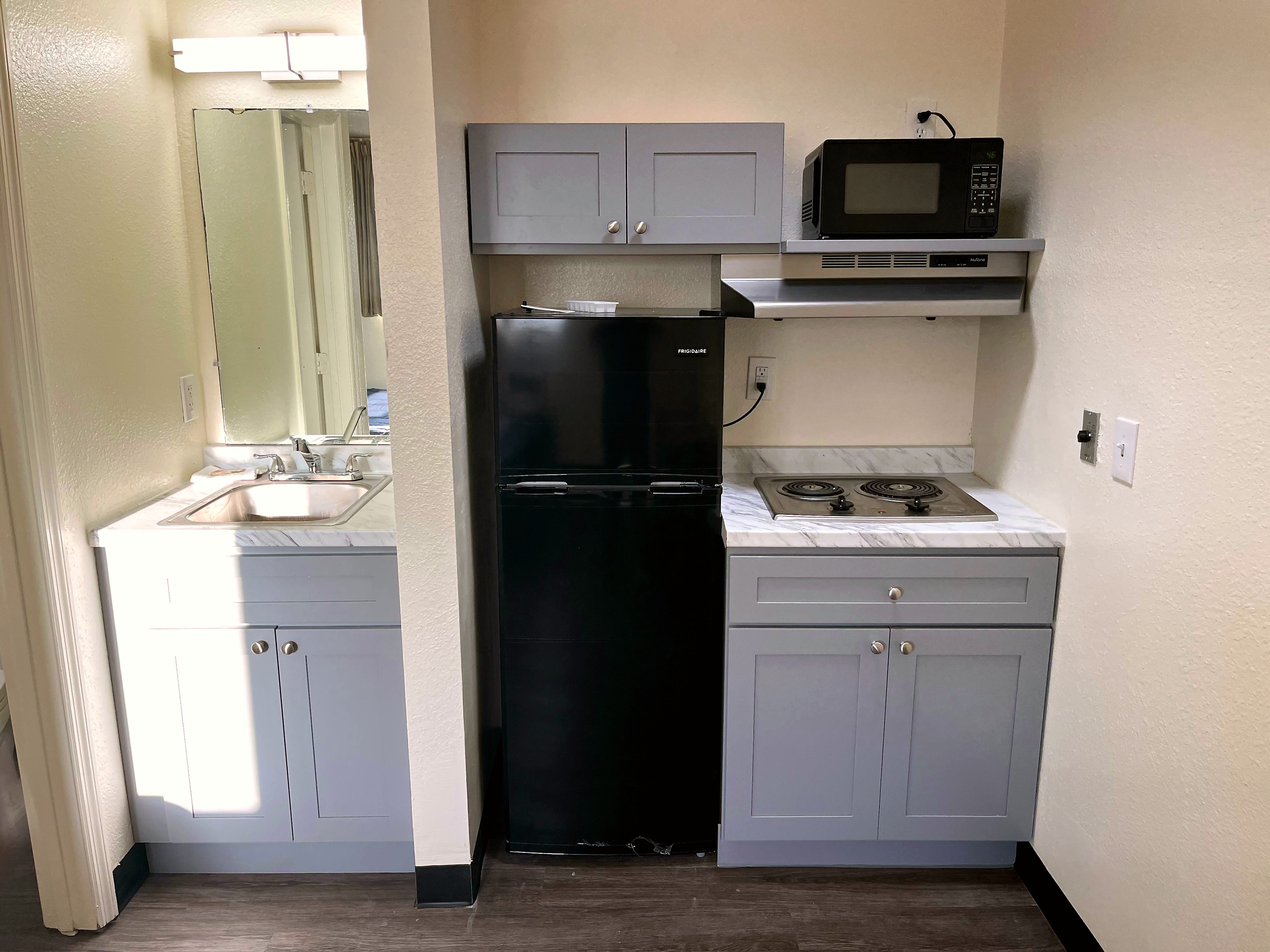 Savannah kitchenette sink, refrigerator, microwave, and cooktop