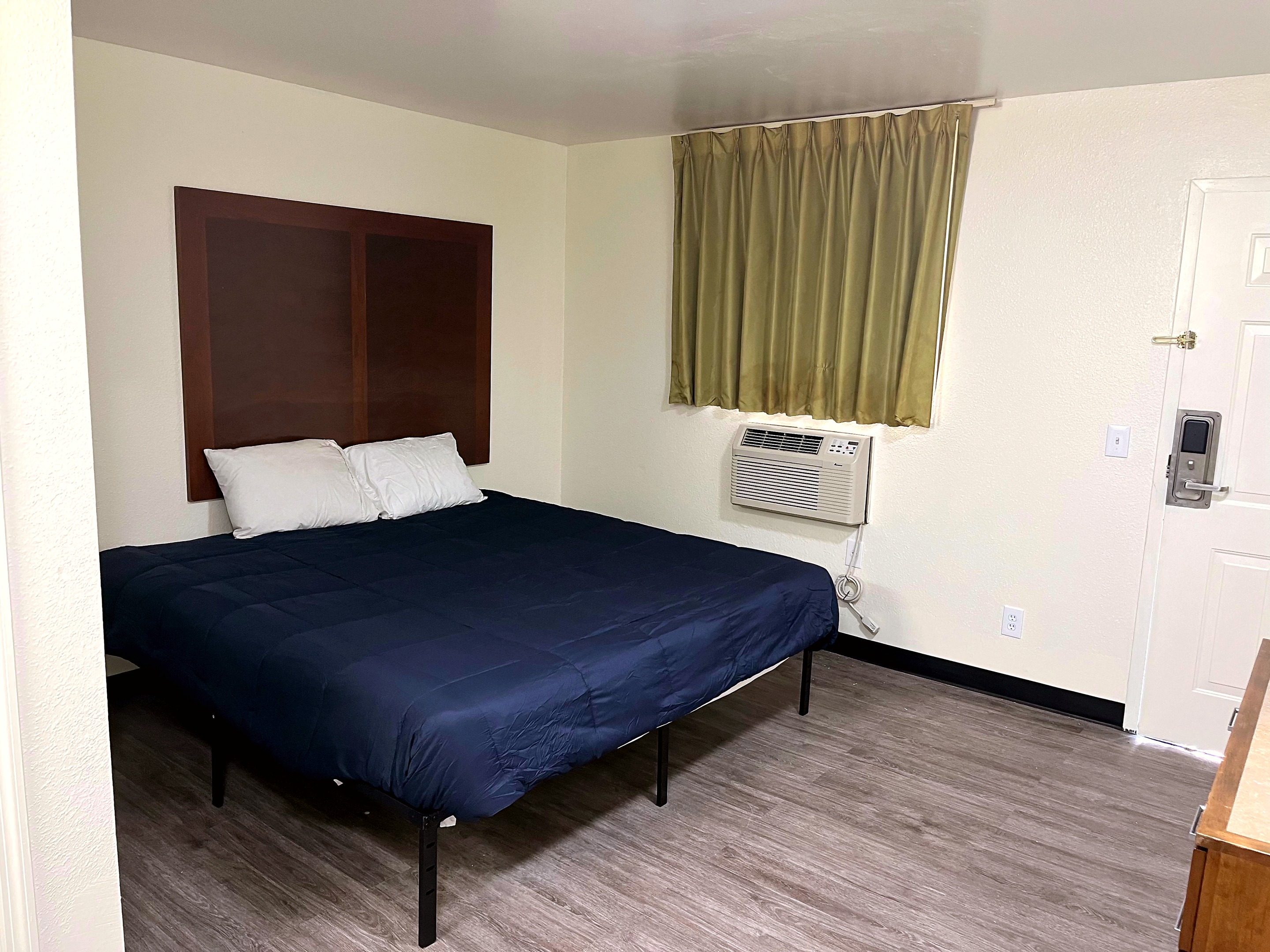 Savannah queen room with window and wall air conditioner