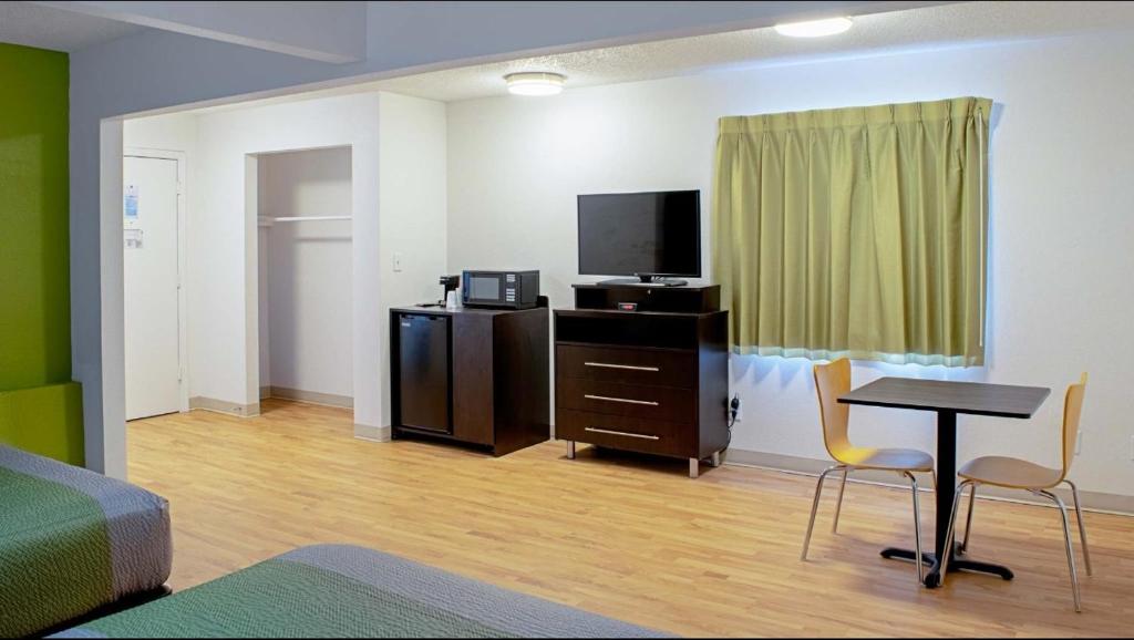 Springdale room with two beds, television, microwave, and refrigerator